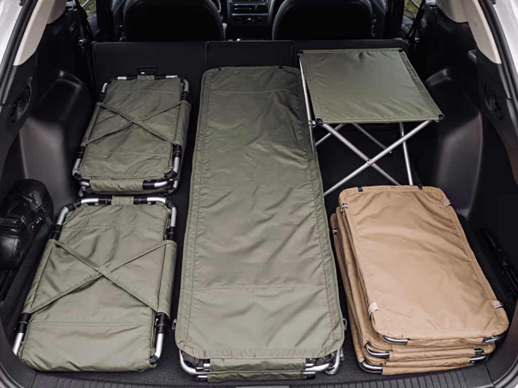 flat-pack_camp_furniture_layout_showing_nested_chairs_and_tables_in_vehicle_trunk
